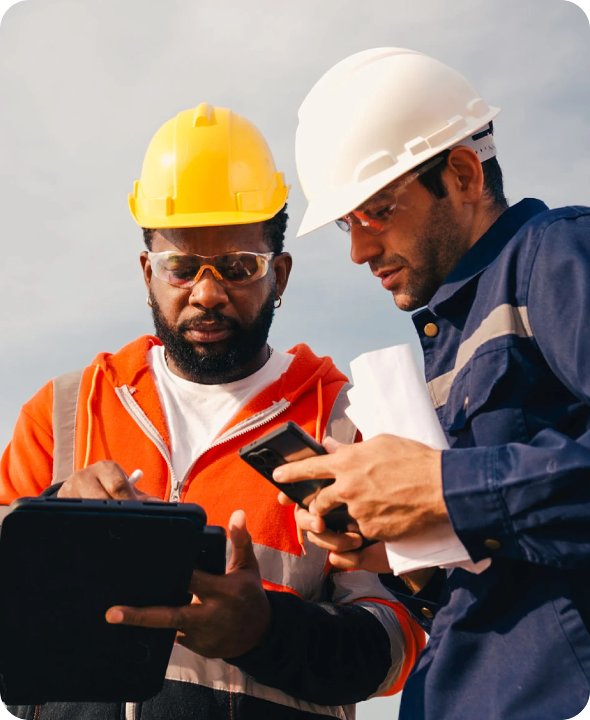 Construction workers reviewing plans on site